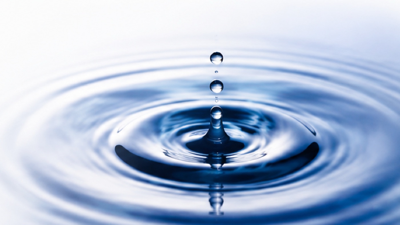 Concentric ripples spreading from a single water drop